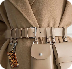 Beige trench coat with a belt and leopard print NFC key fob attached to it