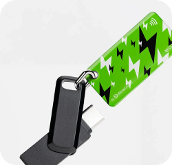 Green energy NFC keychain attached to a black flash drive