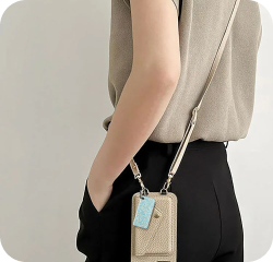 Person with a cross-body phone case with NFC keychain attached to the phone case