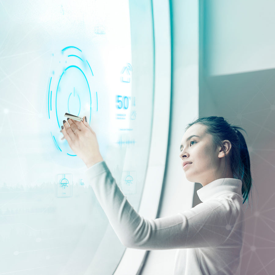Woman interacting with a futuristic digital interface on a transparent screen using an nfc keychain.
