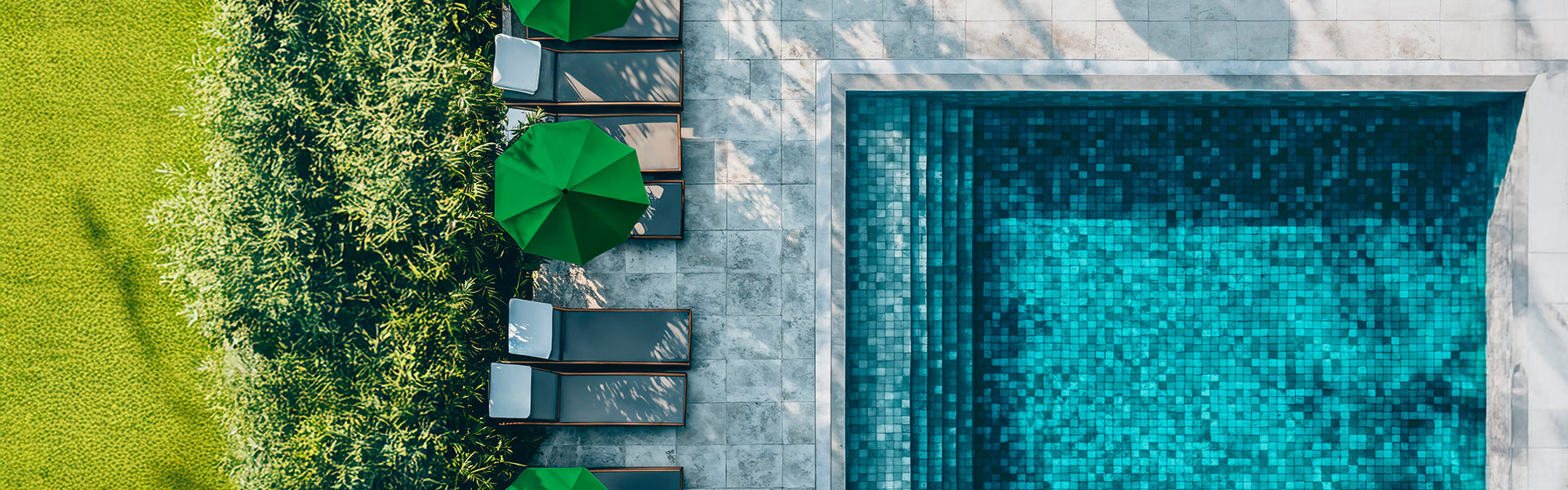 Top-down view of a pool with lounge chairs and green umbrellas in a garden setting.