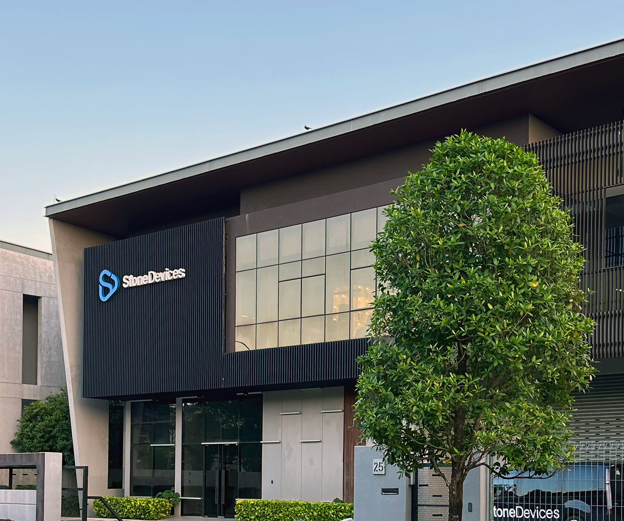 Modern building with "StoneDevices" logo